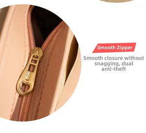 Detail of smooth gold heart zipper and pink leather texture on a crossbody bag