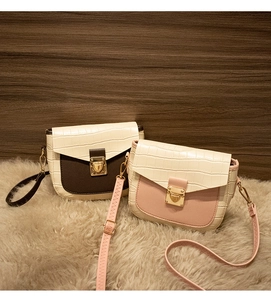 Close-up of mini flap crossbody bags with crocodile texture and gold heart buckles