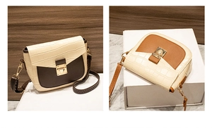 Detail view of two-tone crossbody bags with croc-embossed leather and metal buckle