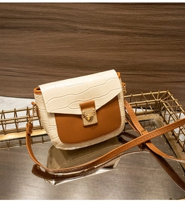 Detail of contrast square bag with crocodile pattern flap and heart-shaped gold lock