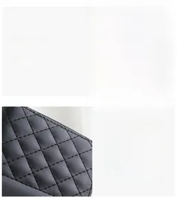 Detail of black quilted leather texture with gold oval hardware and crystal studs