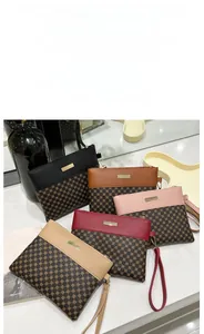 Detailed close-up of colorful printed clutch handbags with zipper and wristlet straps