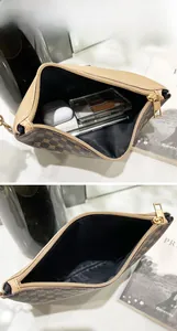 Internal view of a printed handbag showing storage space for makeup and phone