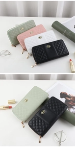 Detailed close-up of quilted tri-fold wallet zipper with elegant gold hardware accents