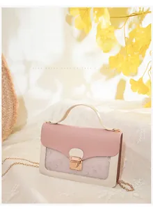 Close-up of contrast color handbag with star mesh detail and gold metal buckle hardware
