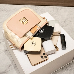 Chic cream and pink croc-effect crossbody bag with gold buckle and daily essentials