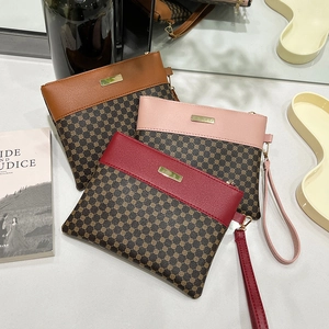 Three elegant printed wristlet handbags in brown, pink and red with gold metal detail
