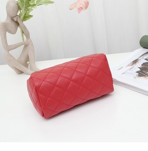 Detailed close-up of a red quilted leather handbag with premium stitching texture
