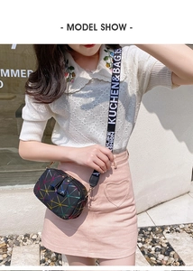 Close-up of small crossbody bag featuring colorful geometric prints and wide logo strap