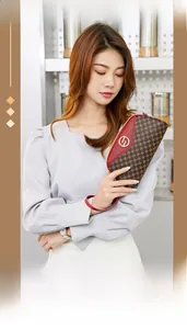 Close-up of elegant women shell clutch bag with monogram print and red wrist strap