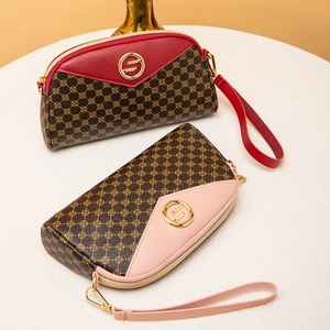 Women's vintage geometric shell clutch bags in brown and pink PU leather set on white table