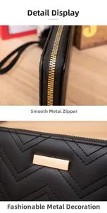 Detailsicht des glatten goldenen Reißverschlusses und Steppmusters auf schwarzem Leder