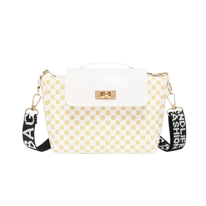 White quilted shoulder bag with yellow geometric print and gold twist lock closure