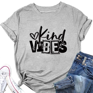 Flat lay of gray Kind VIBES t-shirt with heart graphic, blue jeans and white sneakers
