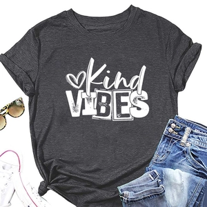 Flat lay of grey T-shirt with Kind VIBES print, rolled sleeves and denim shorts