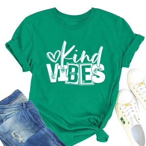Flat lay of green Kind Vibes cotton t-shirt with blue denim jeans and white sneakers