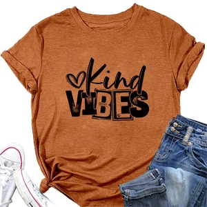 Flat lay of orange Kind VIBES T-shirt with blue denim jeans and white sneakers