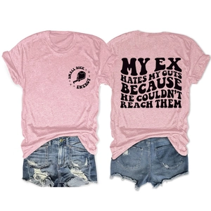 Flat lay of pink casual t-shirt with slogan print and distressed denim shorts