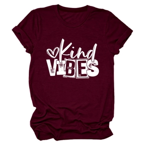 Flat lay of maroon crew neck t-shirt featuring Kind VIBES text and heart graphic