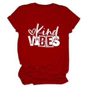 Detailed close-up of red cotton t-shirt featuring white Kind VIBES text and heart graphic