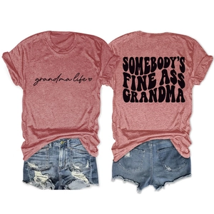 Flat lay of vintage red t-shirts with grandma life print and distressed denim shorts