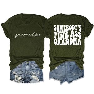 Close-up of olive green t-shirt with Somebody's Fine Ass Grandma text and denim shorts