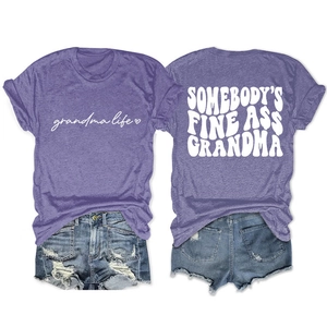 Flat lay of heather purple grandma life t-shirt and distressed blue denim shorts