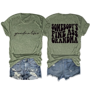 Flat lay of green t-shirt with Somebody's Fine Ass Grandma text and denim shorts