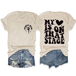 Detailed flat lay of beige T-shirt with My Heart Is On That Stage back print and denim shorts
