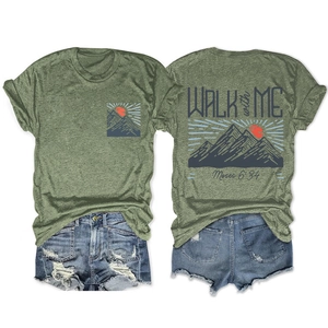 T-shirt vert avec graphique de montagne et citation de Moïse à côté d'un short en jean
