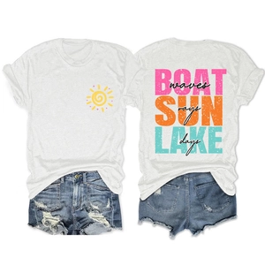 Detail of white t-shirt with sun print and distressed blue denim shorts flat lay