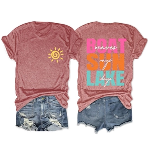Flat lay of a red heathered t-shirt featuring lake life prints and distressed denim shorts