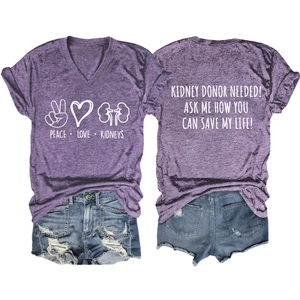 Detailed flat lay of purple V-neck t-shirt with kidney donor graphics and denim shorts