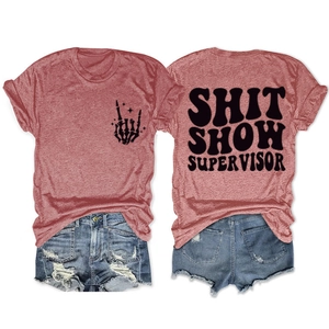 Flat lay of heather red t-shirt with Shit Show Supervisor text and ripped denim shorts