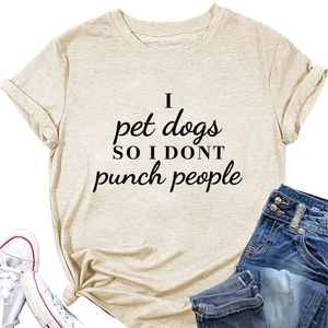 Close-up of beige t-shirt with I pet dogs text paired with jeans and sneakers