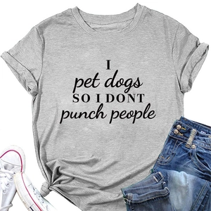 Flat lay of gray T-shirt with 'I pet dogs' slogan paired with denim shorts and shoes