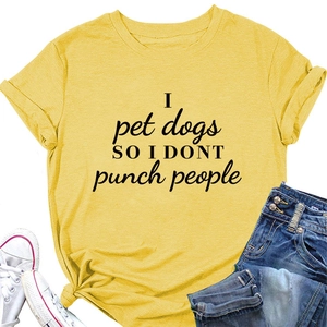 Detail view of yellow cotton t-shirt featuring 'I pet dogs' humor slogan typography