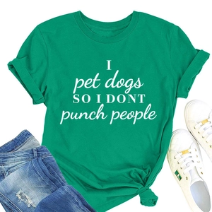 Flat lay of green cotton t-shirt with slogan, blue ripped jeans and white sneakers