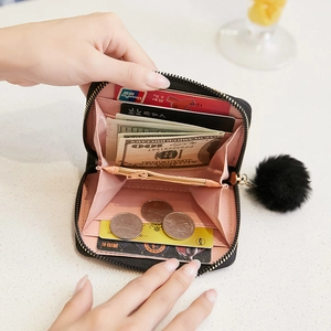 Women short black wallet with wavy stitching, pompom pendant and functional card slots