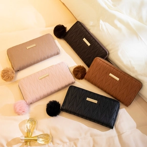Quilted women's long wallets in five colors with metal bar and soft fur pompom charms