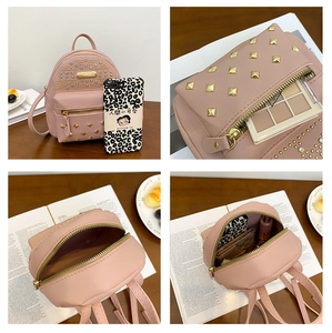 Detail view of pink mini backpack showing studded design and internal storage capacity