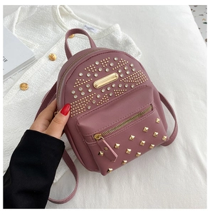Close-up of mini studded backpack in soft purple faux leather with gold rivet details