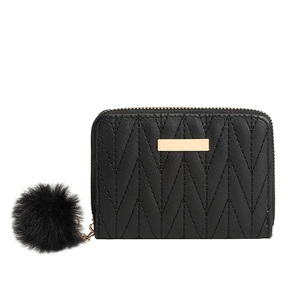 Quilted black short wallet for women with golden hardware and fluffy faux fur pompom