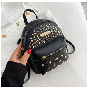 Detail shot of black PU leather mini backpack featuring golden studs and rhinestones