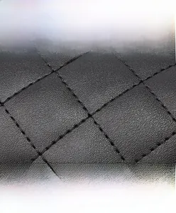 Detail of black quilted faux leather fabric featuring durable diamond stitching pattern