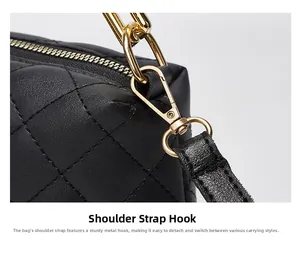 Detailed close-up of durable golden metal hook and detachable strap on black quilted bag
