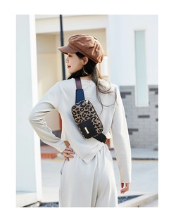 Detail of leopard print running fanny pack with gold zippers and adjustable strap