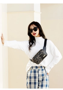 Detail of trendy leopard print waist bag with gold zippers and adjustable strap for women