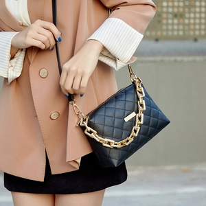 Classic black quilted crossbody bag with gold chain strap and elegant matte leather finish