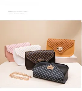 Detailed view of mini square crossbody bags with geometric prints and gold metal clasps